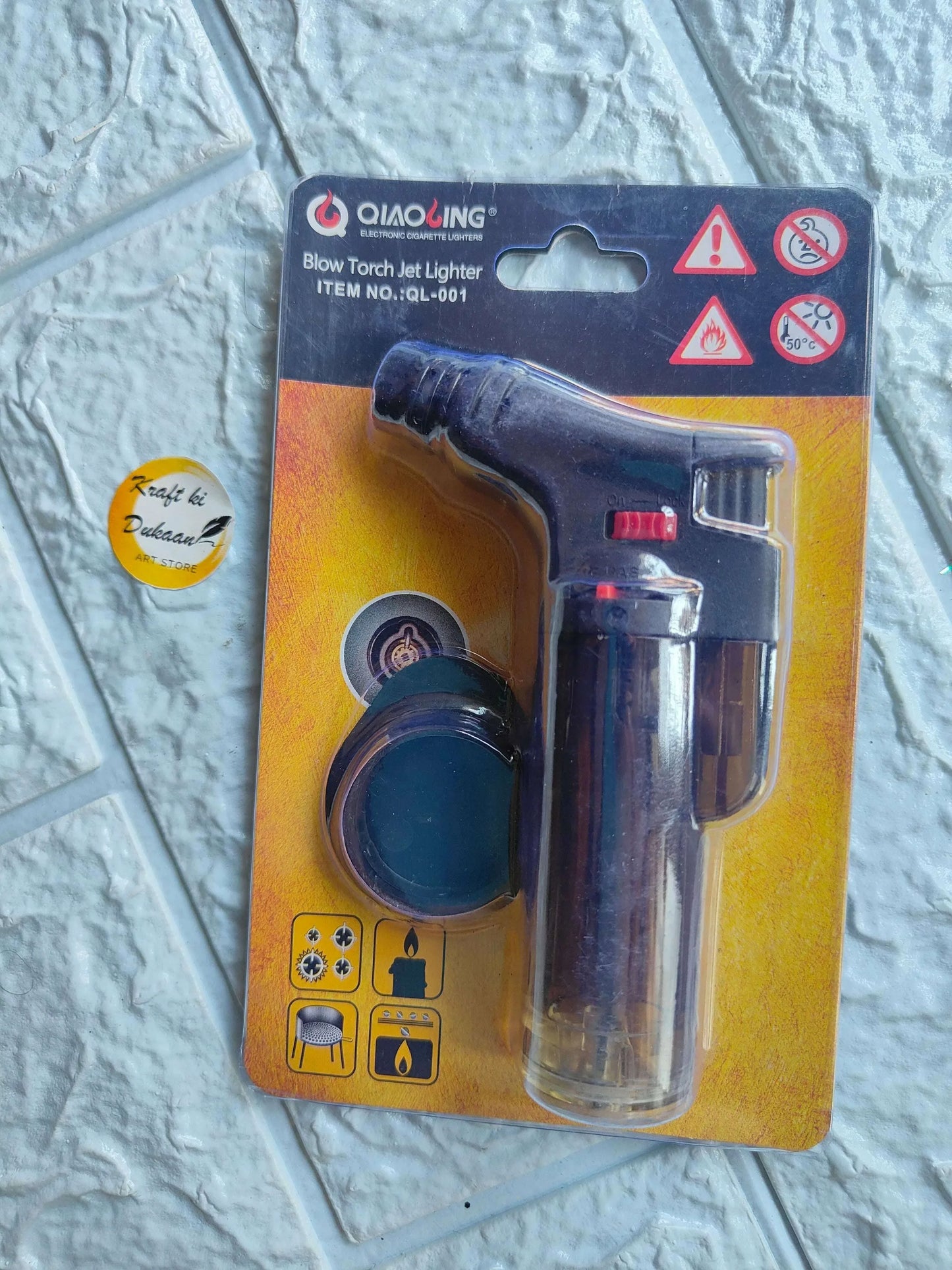 Blow Torch jet lighter with black grip, red switch, and clear metal fuel canister