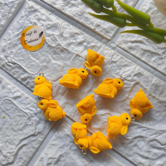 Rabbit charm pendants set (10) in yellow; rabbit figures with metal loops