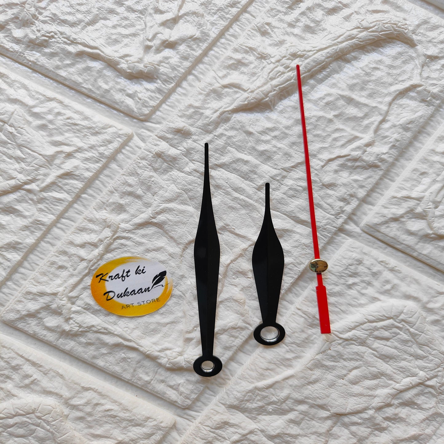 Red and black clock hands set for DIY clock projects, featuring one long red hand and two black hands