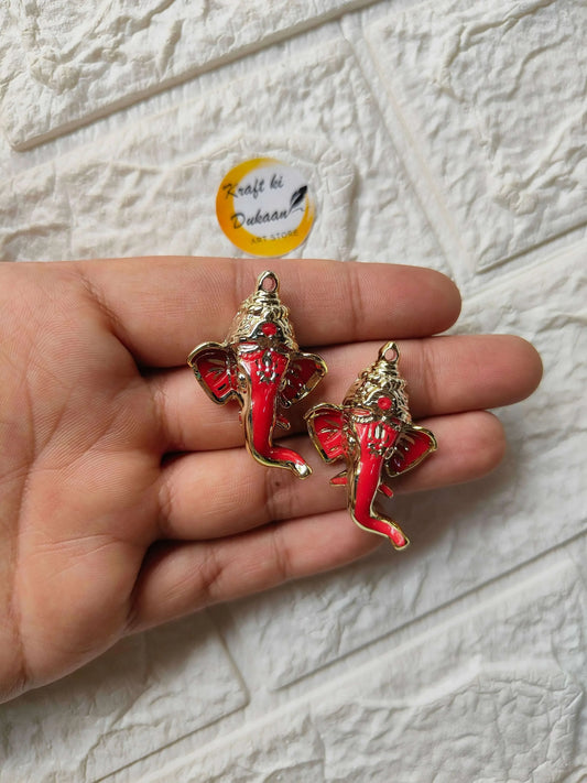 Red Ganpati face charms, gold-tone finish, two pendants on hand