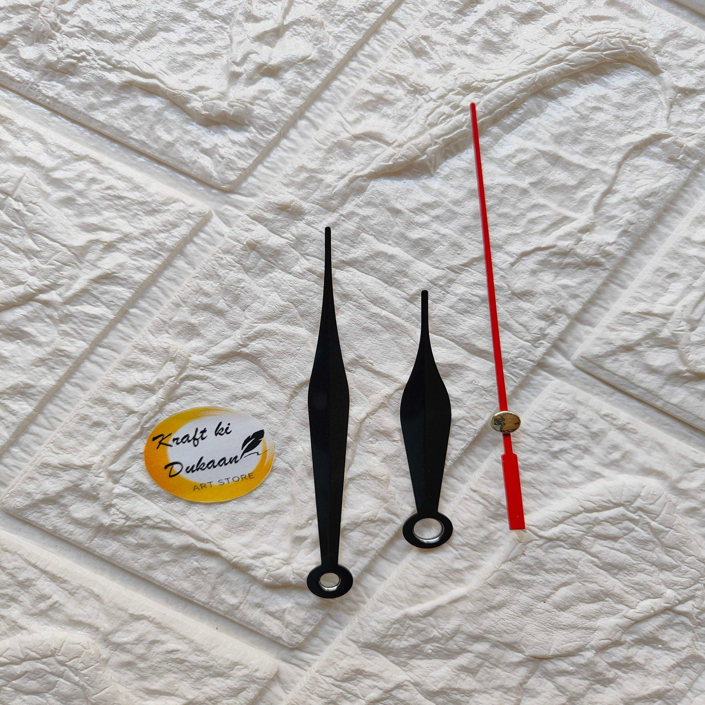 Red and black metal clock hands set with gold tips, C1 design