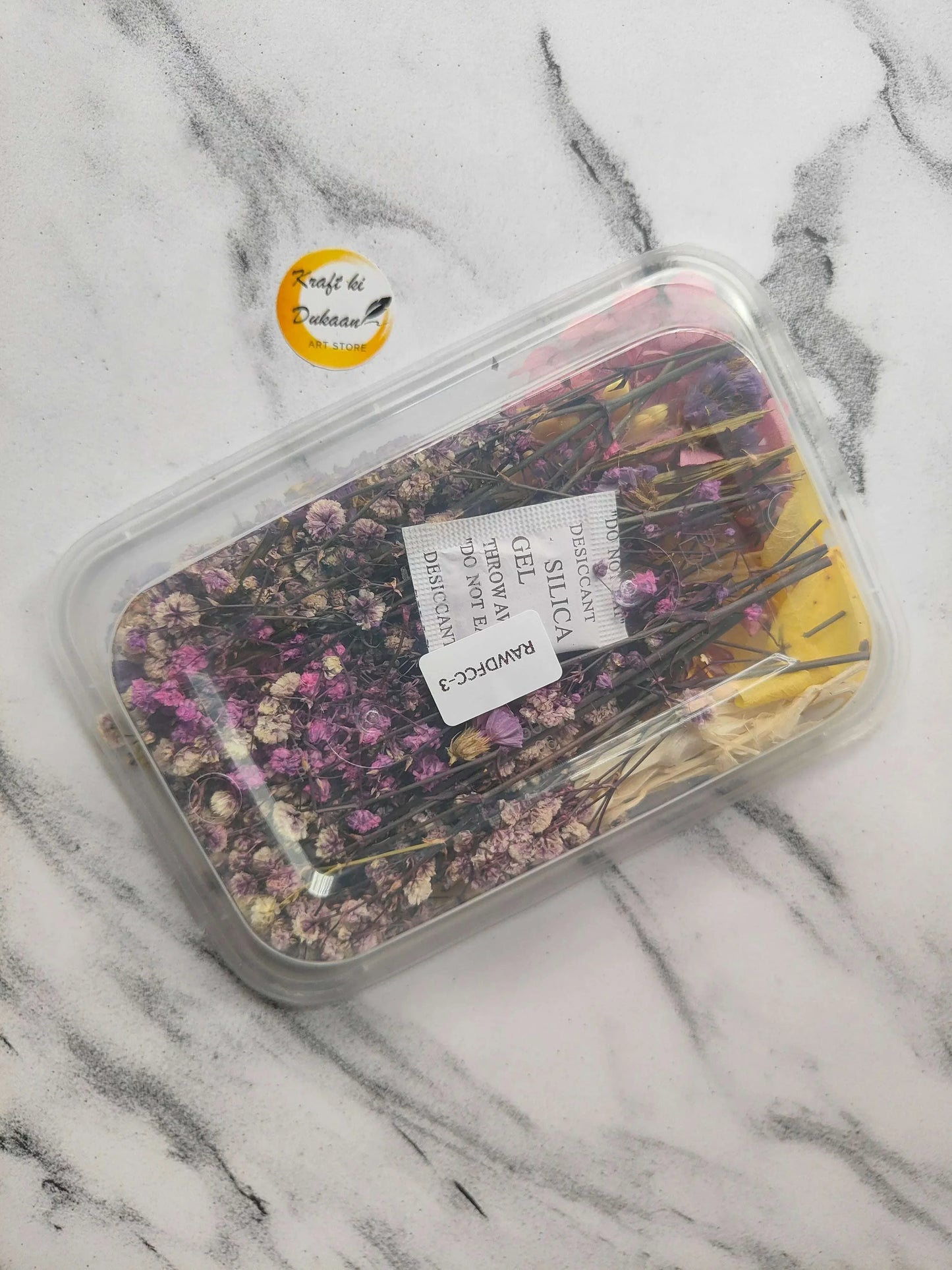 Dry Flower Box E5: clear container with dark purple and pink dried flower pieces, label
