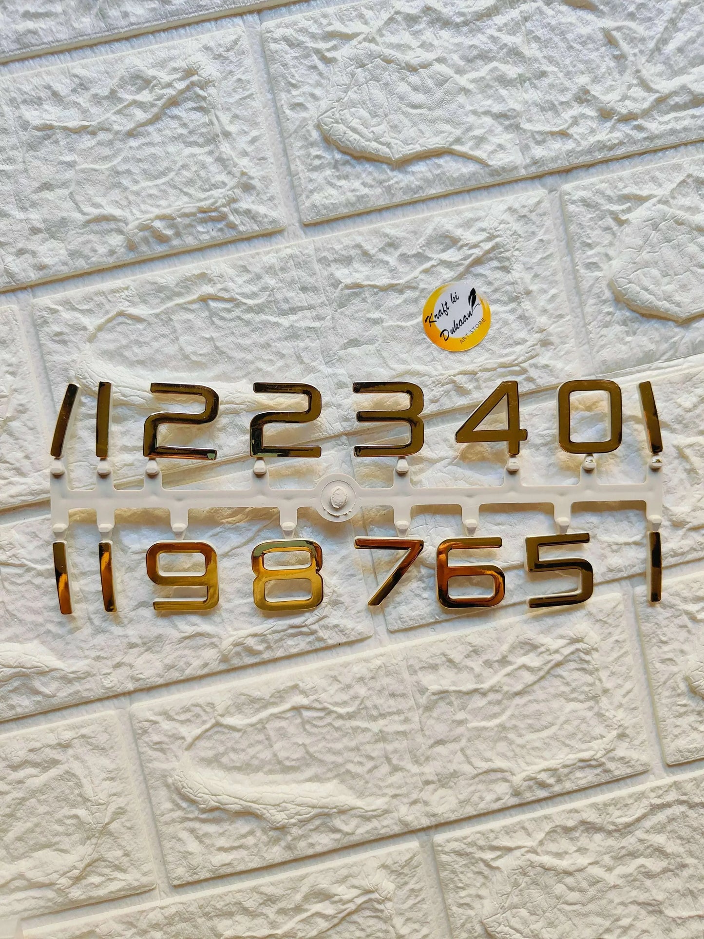 Gold clock number set with raised metal digits 0–4 and 5–9 on backing