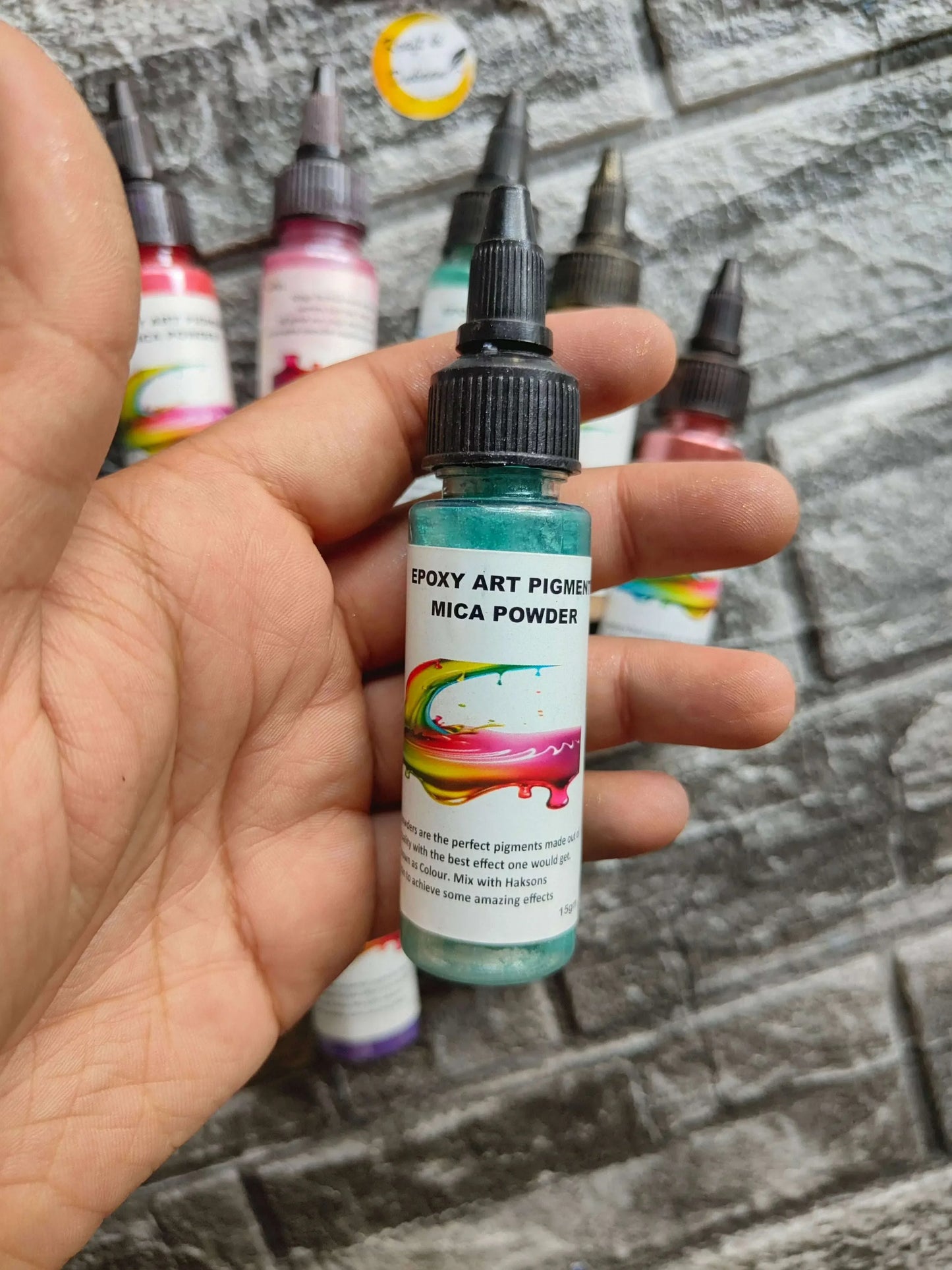 Resin mica pigment powder bottle with black dropper cap and teal-tinted contents
