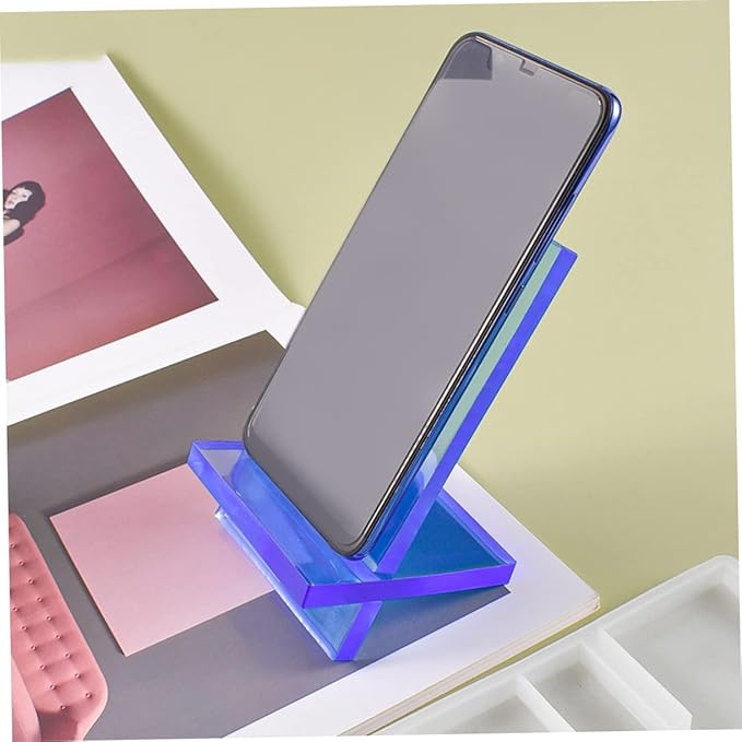 Resin mobile phone stand mould displayed with a smartphone on a stylish desk setup