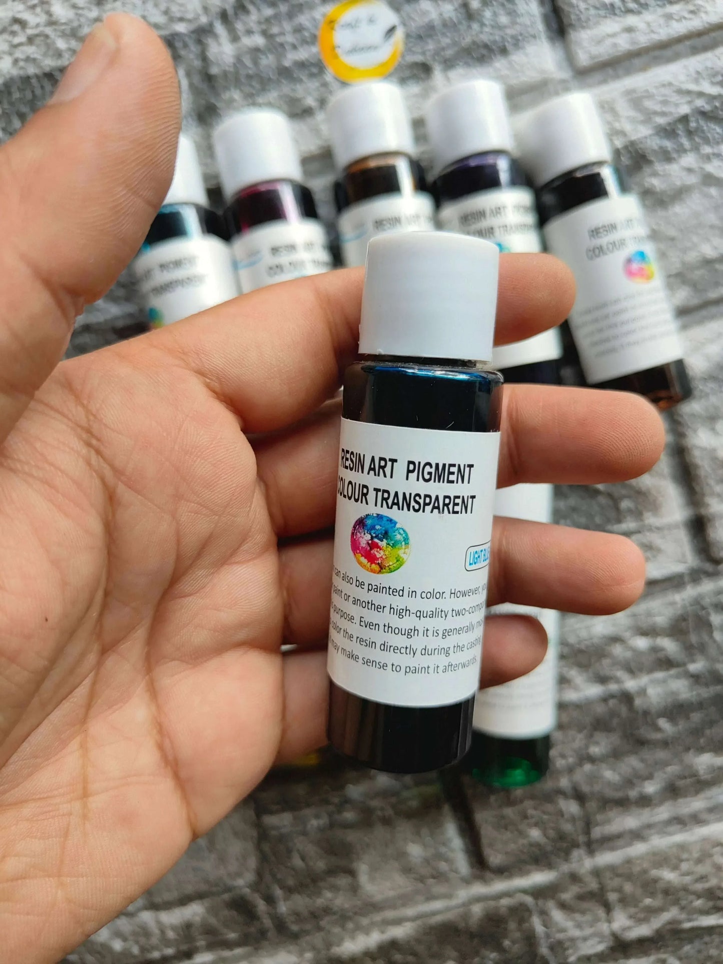 Resin Transparent Pigment bottle close-up with white cap; other bottles in the set