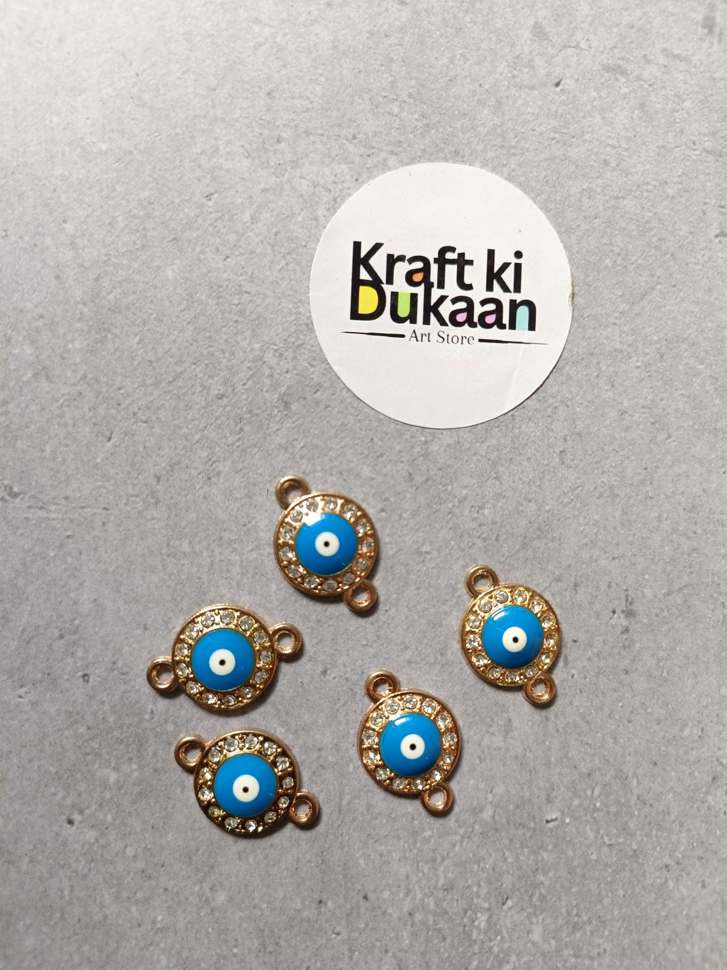 Gold-tone evil eye bracelet charms, five round blue cabochons with rhinestone halo