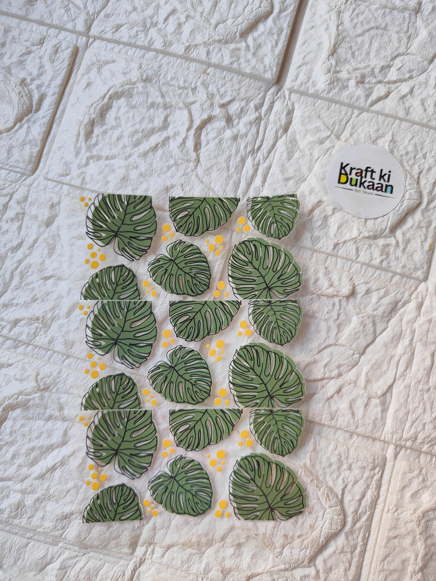 UV DTF peel-off sticker sheet with green monstera leaves and yellow dots, Kraft ki Dukaan