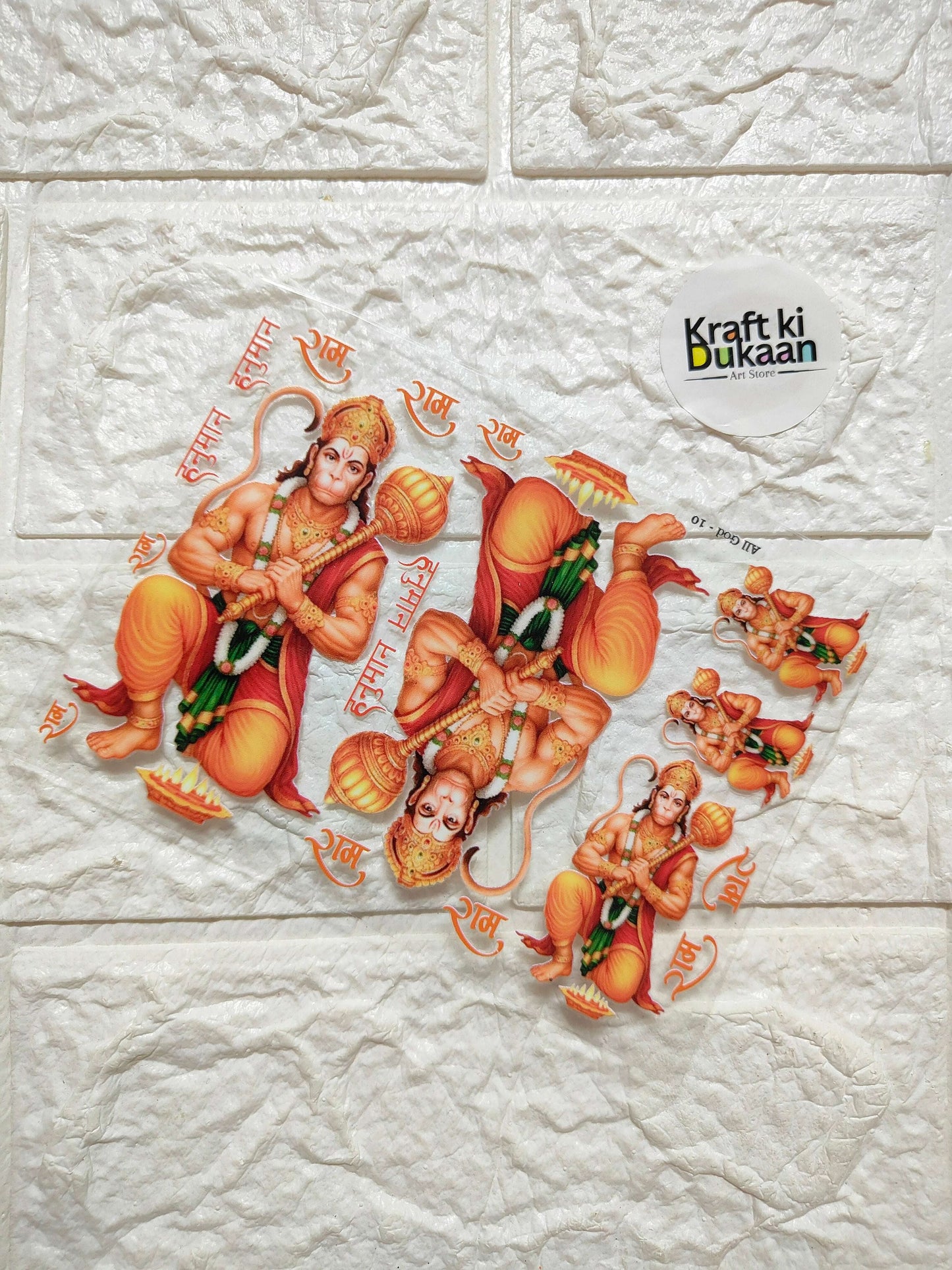 Peel-off sticker sheet with multiple Ganesha figures in orange and gold