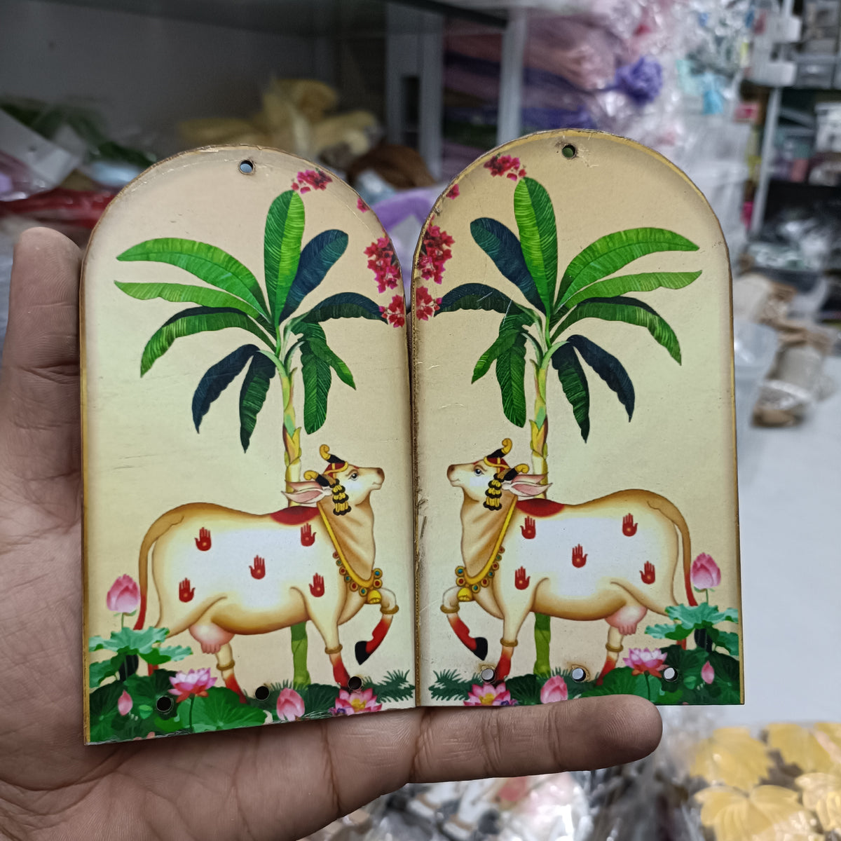 Pair of arched MDF panels with painted cows, green palm leaves, and flowers