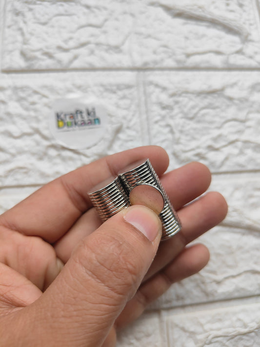 Stacked round steel magnets with center hole, 15 x 1.5 mm, close-up