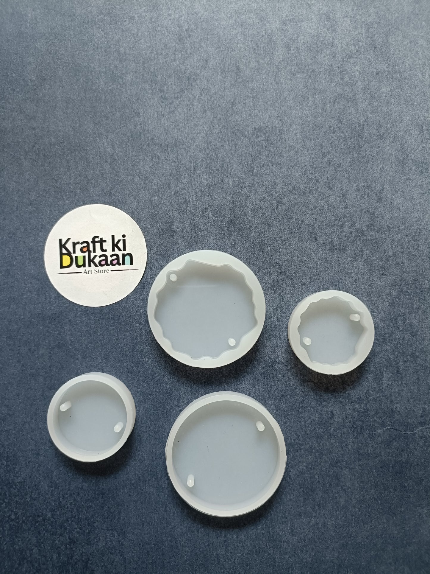Round mould set with four small round cavities in light gray plastic