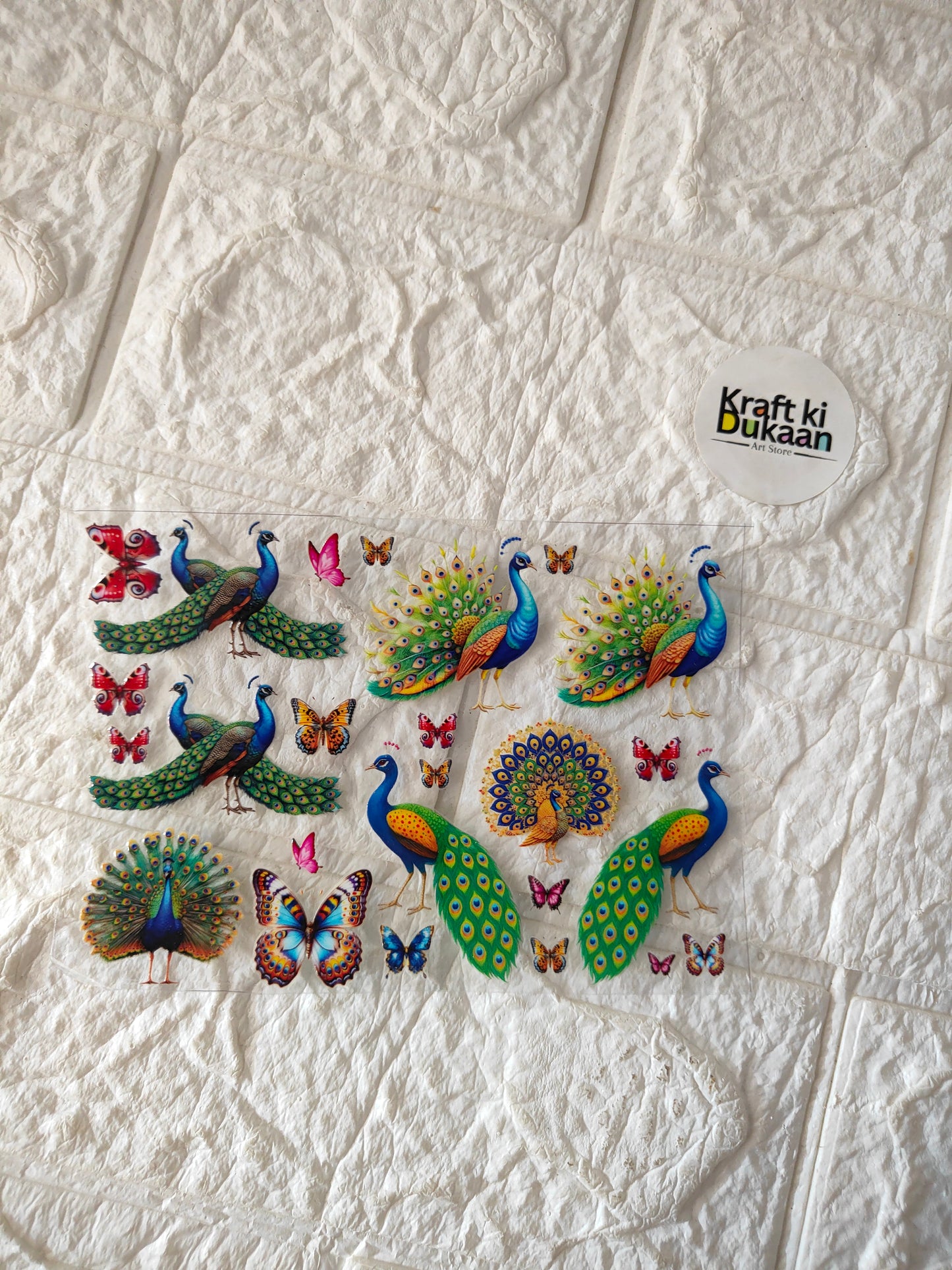UV DTF peel-off sticker sheet with colorful peacocks and butterflies on oval backing