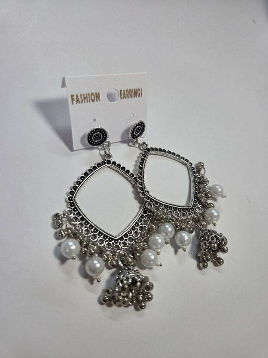Square jhumka earrings with white beads, ornate silver-tone border, and bell drops