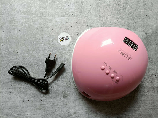 Pink UV LED nail lamp shown from front with digital display and labeled settings