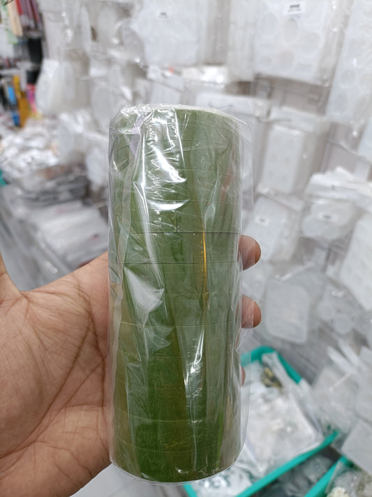 Green floral tape roll on plastic wrap with textured pattern lines