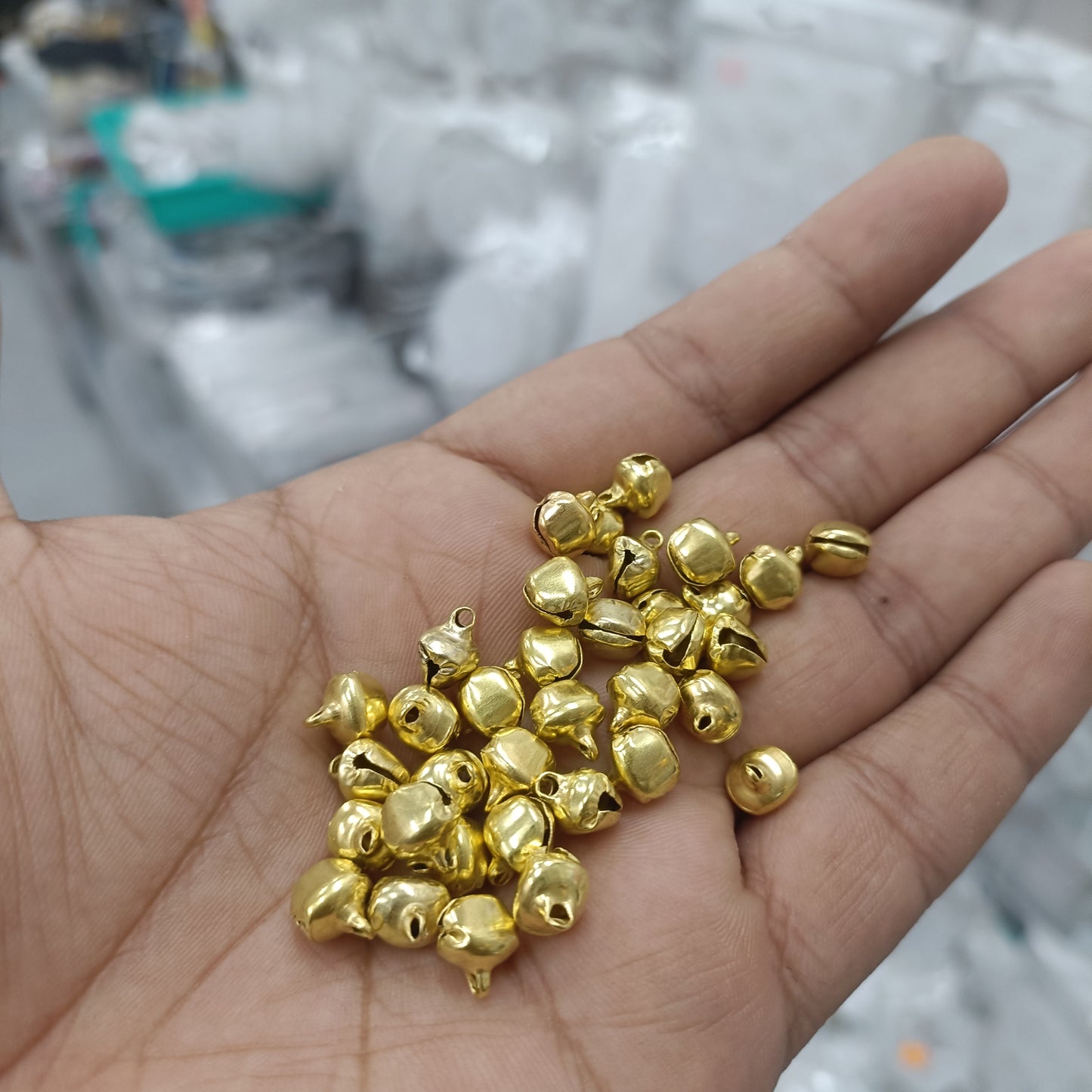 8mm ghunghroo bell beads, small round gold-toned jingles in hand