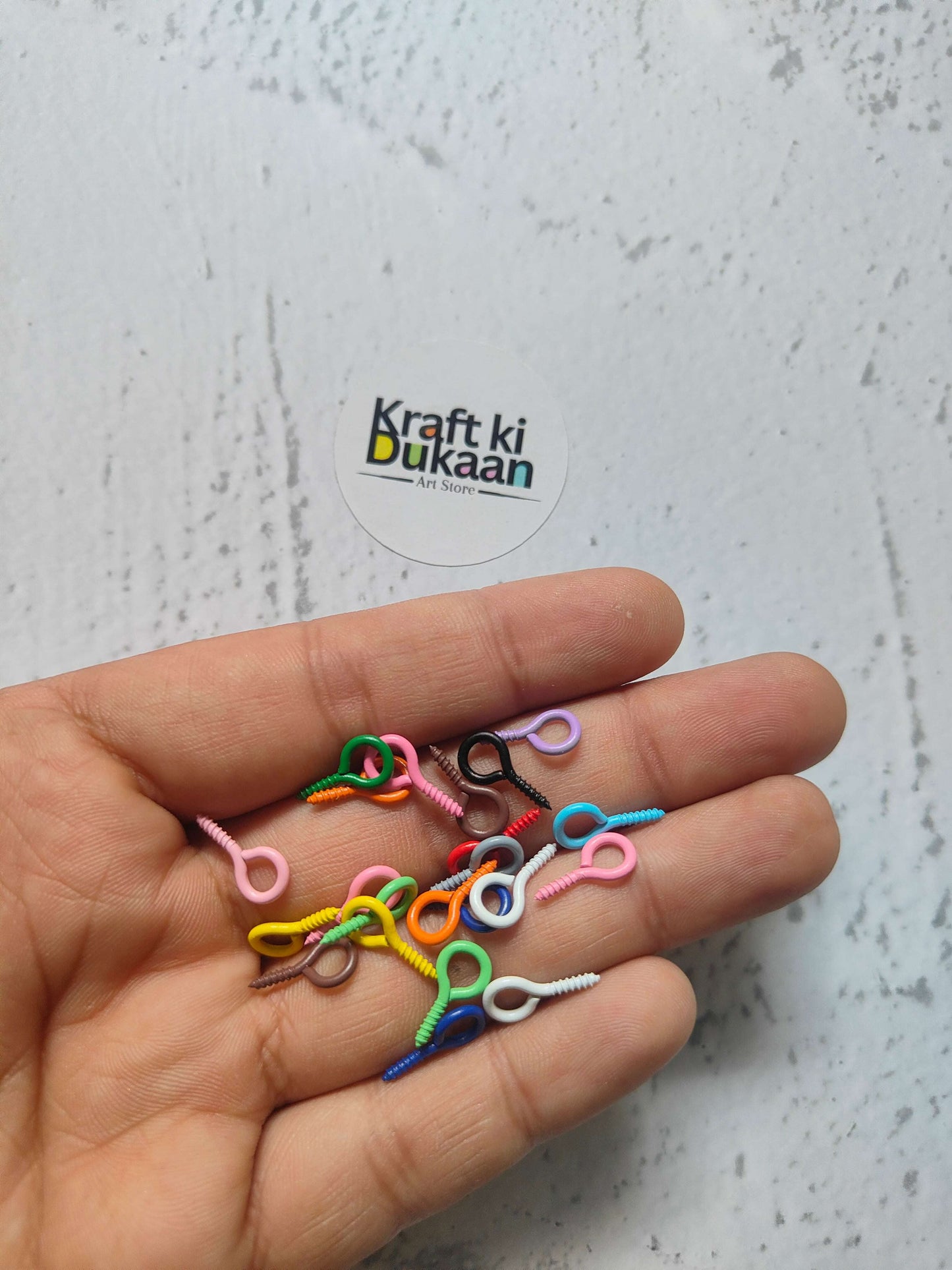 Multicolor eye screw hooks with looped eye and spiral screw points (close-up)