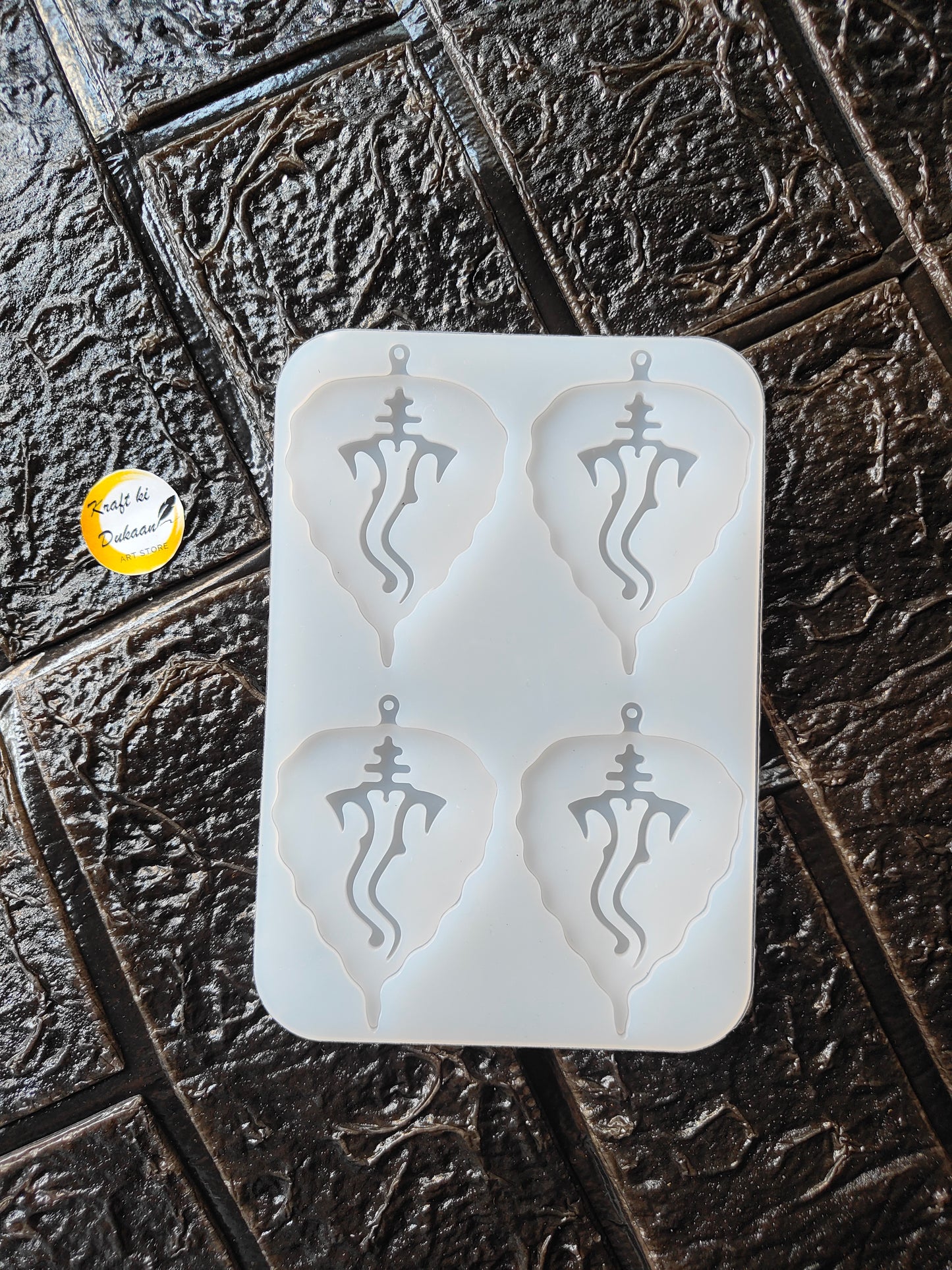Ganesh leaf silicone mould with four raised deity designs, white, rectangular