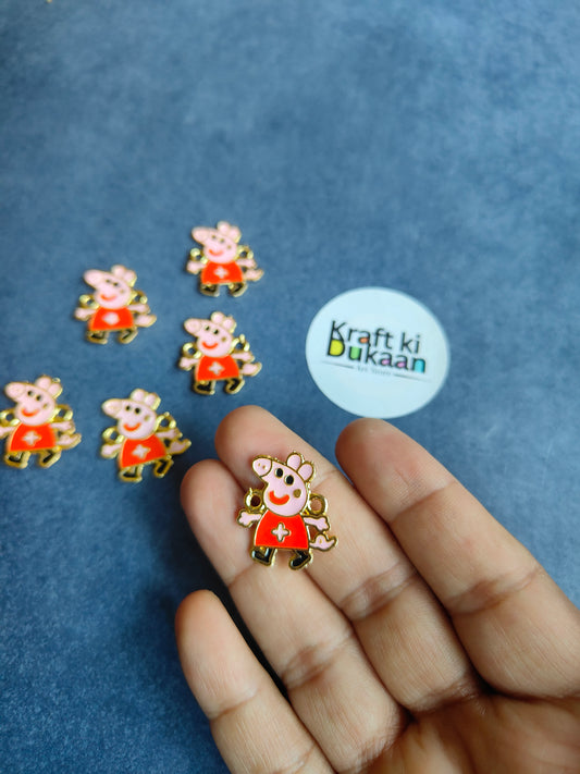 Single rakhi bracelet pendant charm held in hand, cartoon girl in red dress, gold-tone