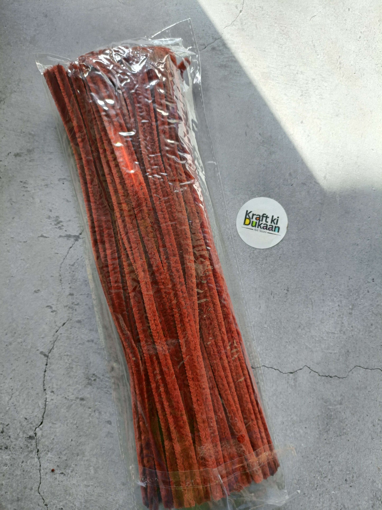 Brown pipe cleaner sticks in clear plastic bag