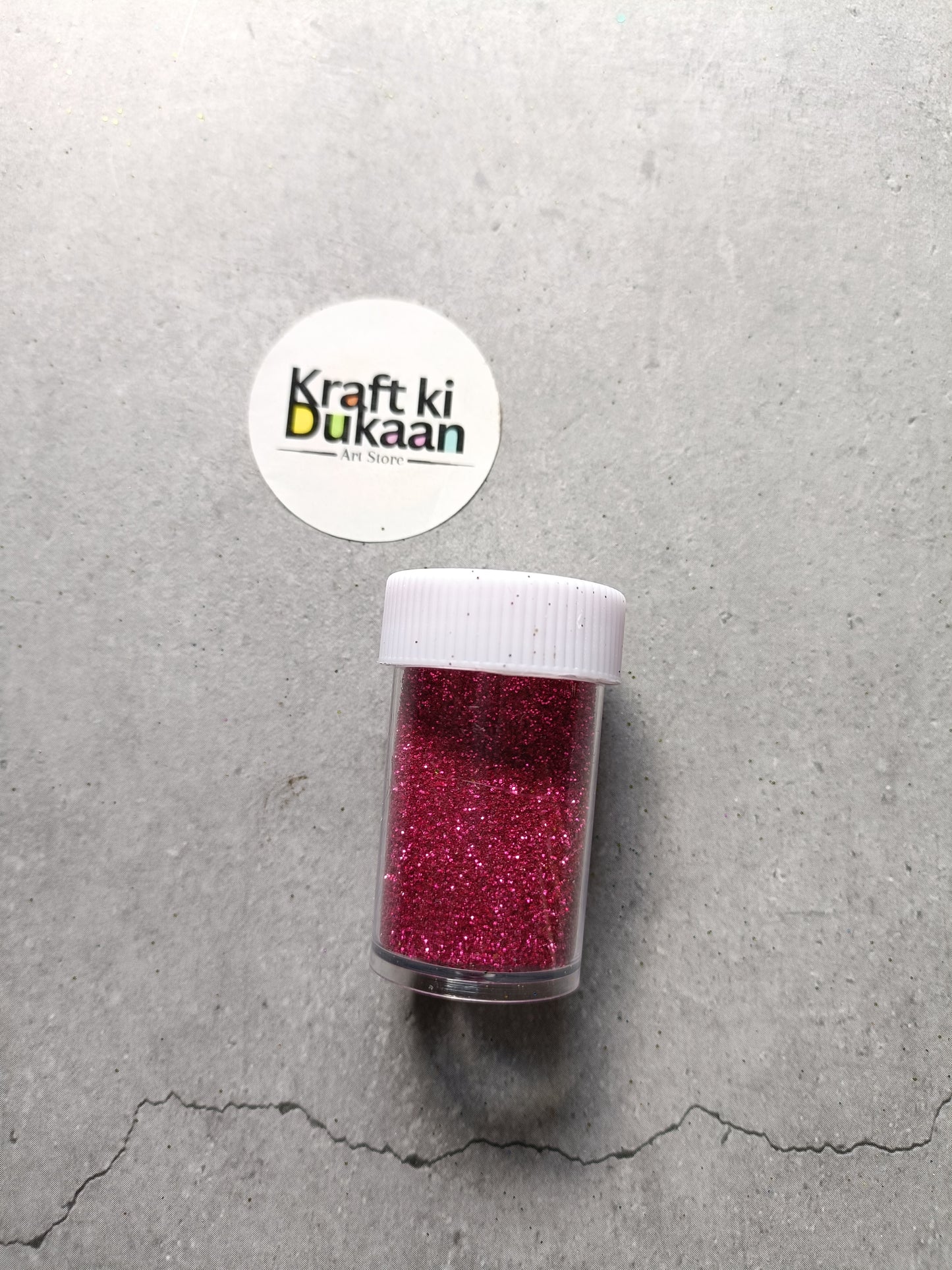 Fuchsia chunky glitter powder in clear shaker bottle with white lid