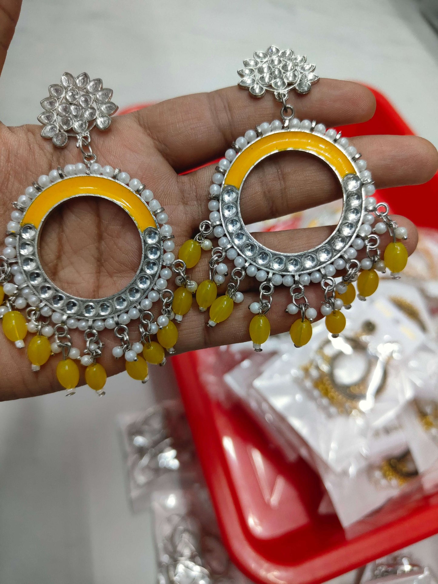 Silver-tone chand bali earrings with yellow teardrop beads and pearl fringe circles.
