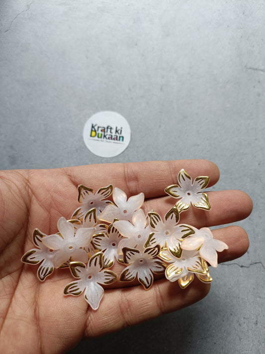 Flower beads pack, white and gold flower shapes in open hand