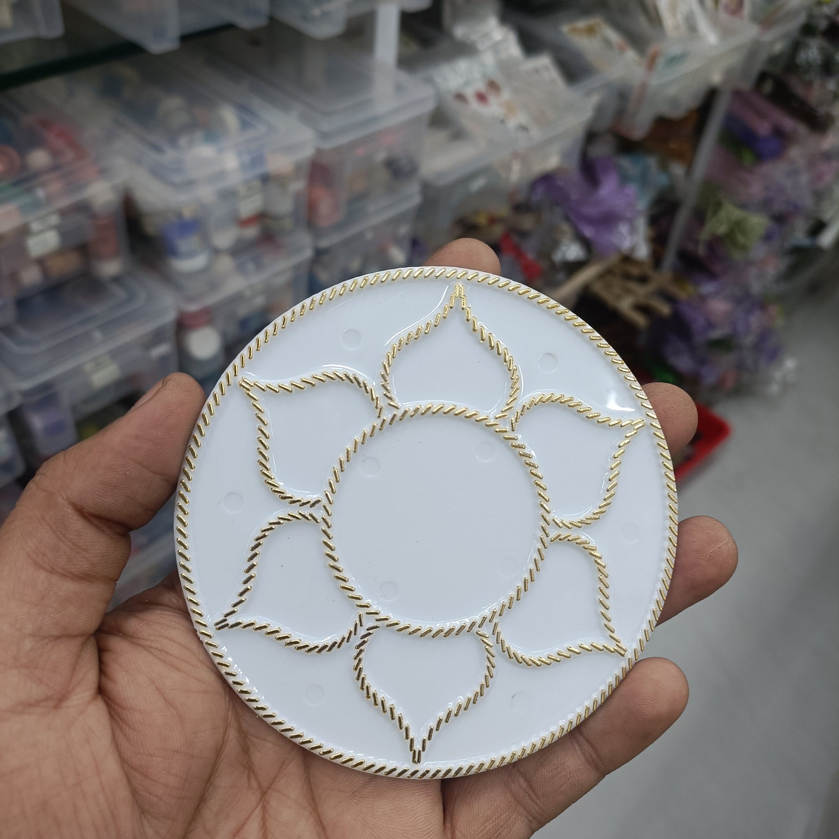 Round white acrylic tealight base with gold floral cutout design