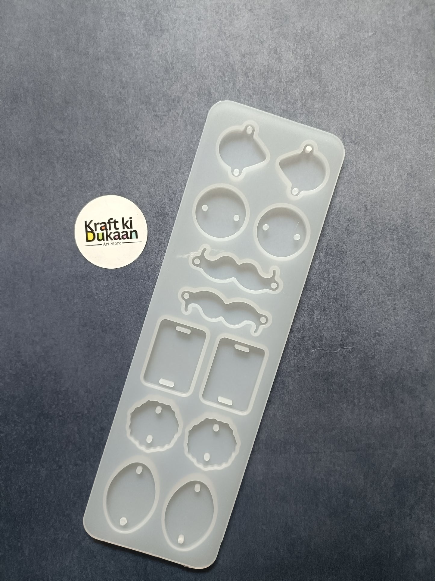 12-cavity rakhi mould sheet with circular, oval, wavy and rectangle cutouts