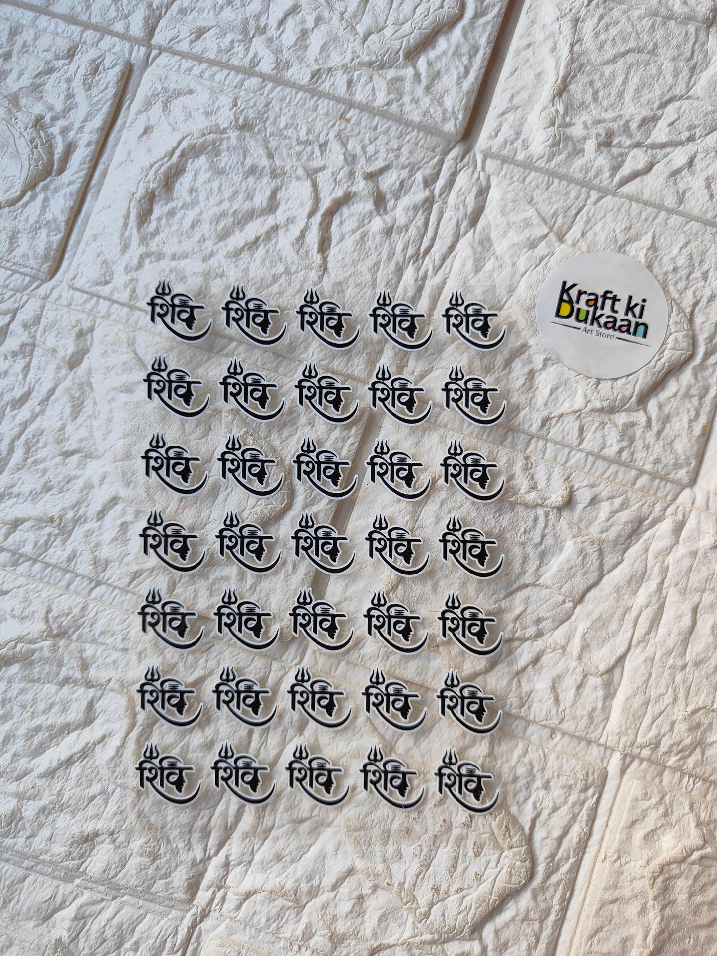UV DTF peel-off sticker sheet with multiple small black Hindi script stickers