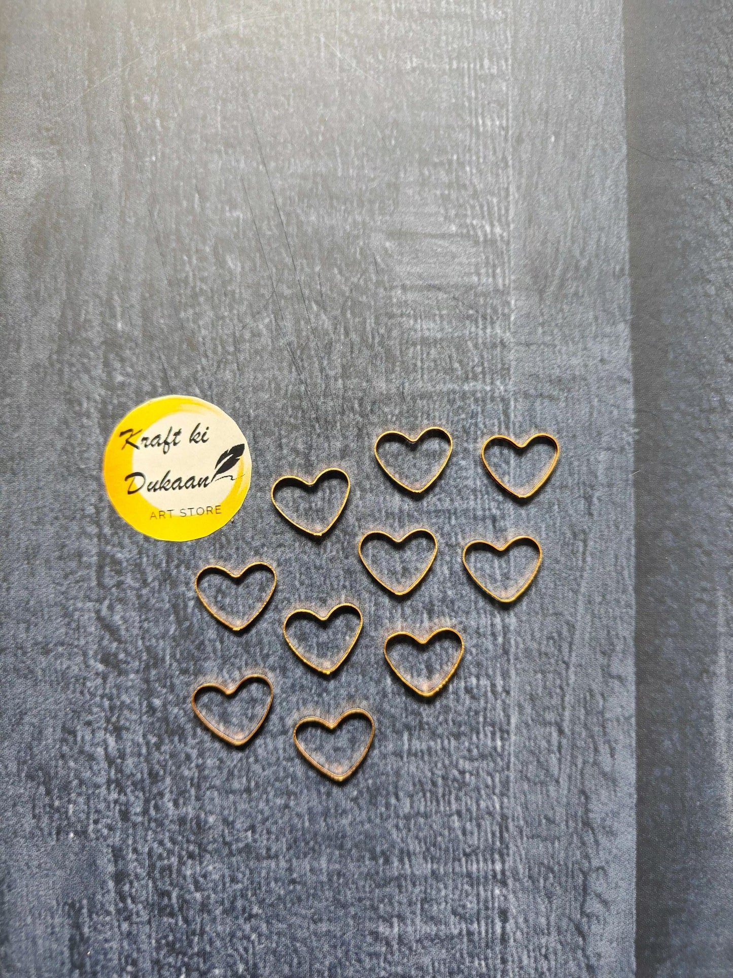 10-piece heart-shaped bezel charms, gold-tone heart settings in a row