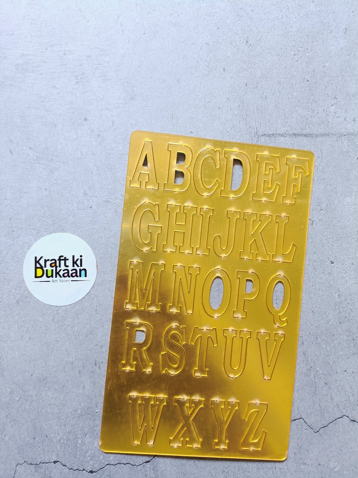 Acrylic alphabet set with gold-tone cutout letters A–Z on a clear plaque