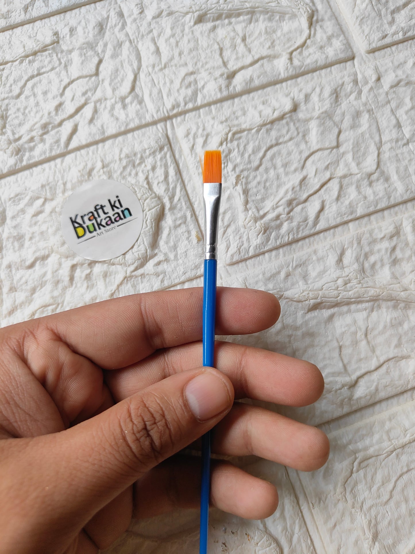 Artist flat No. 2 paint brush with blue handle and orange ferrule, tapered bristles