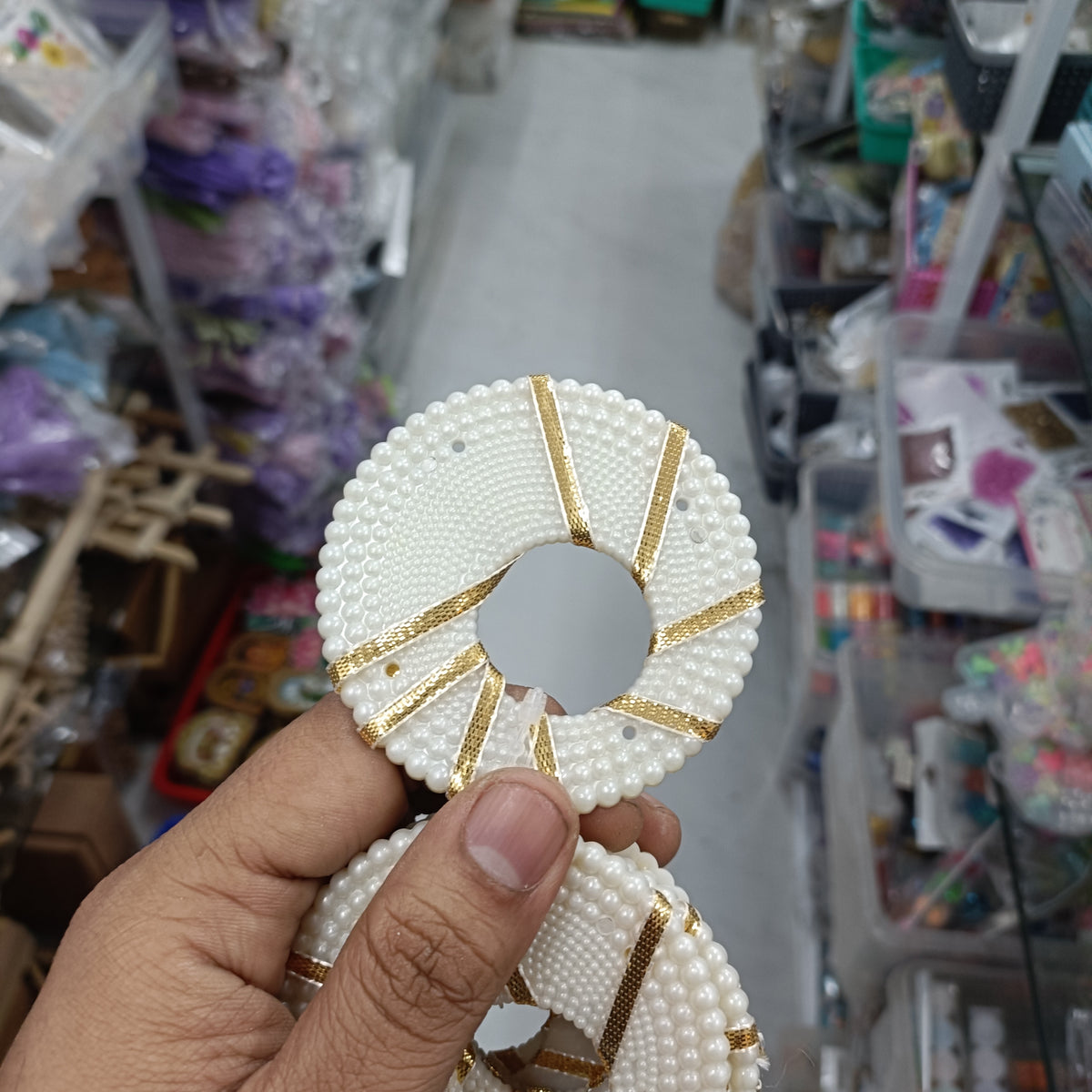 White beaded ring with gold-striped accents, 3-inch diameter