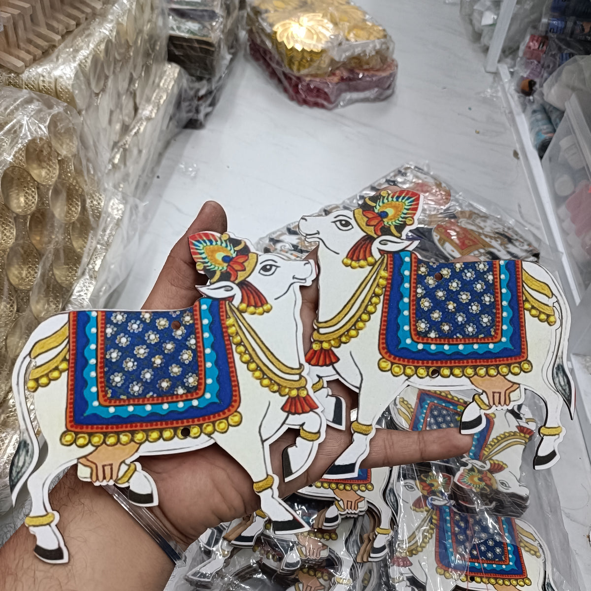 Blue-and-gold cow cutout pair, decorative MDF with patterned saddles