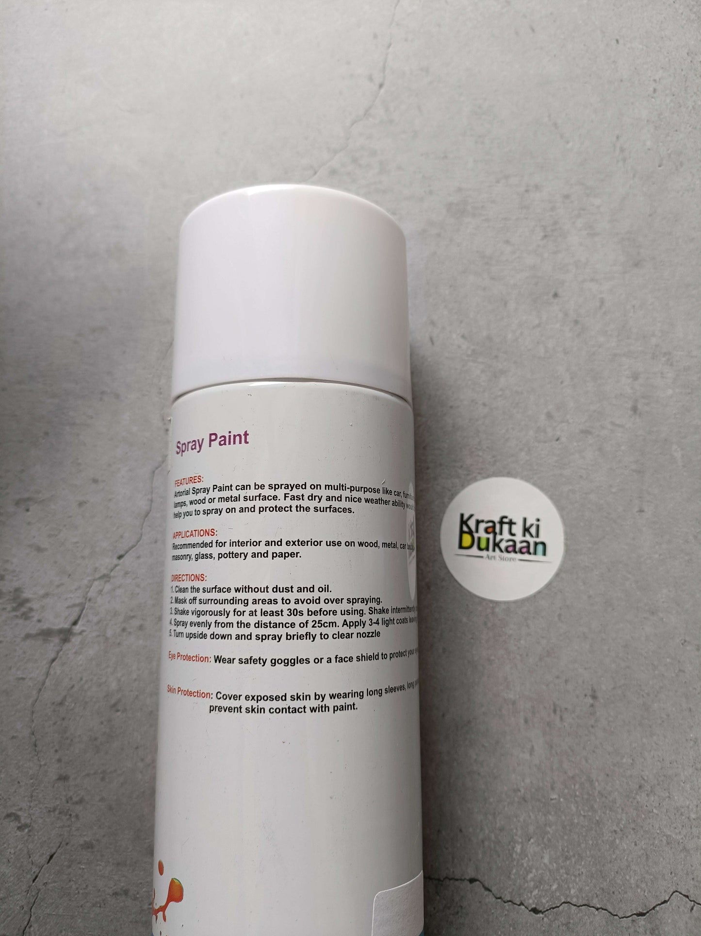 White spray paint can with side information label and round logo