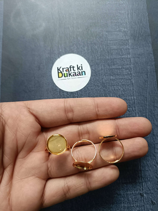 Gold-tone ring bases on palm, small round bezel settings on open bands