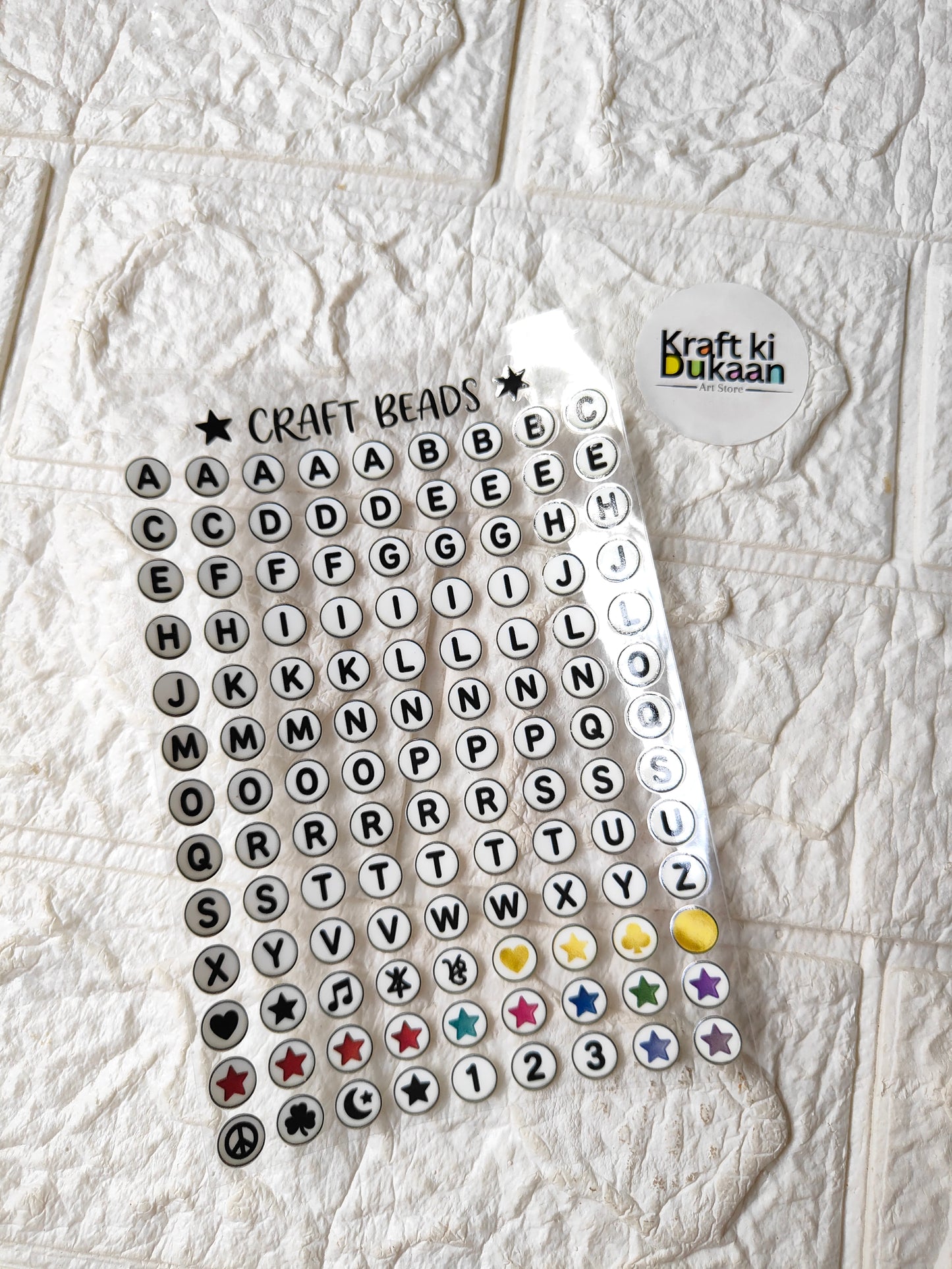 UV DTF peel-off sticker sheet with circular alphabet, numbers, stars, and symbols