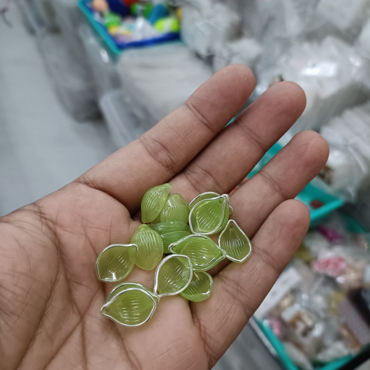 Acrylic petal beads, translucent lime green, assorted pieces in hand