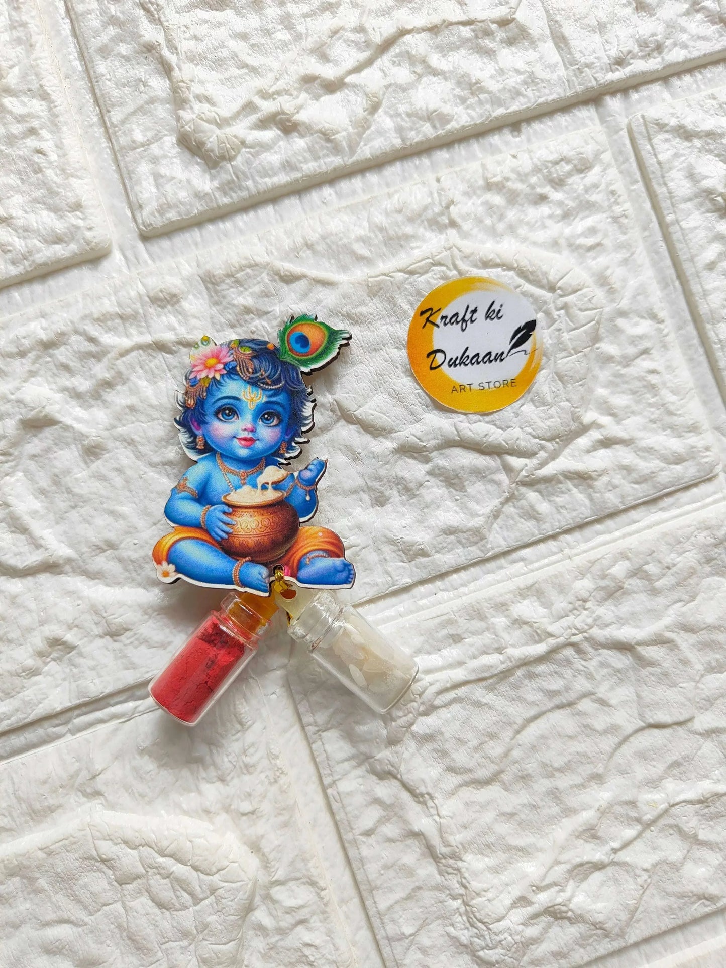 Roli Chawal bottle set with blue Krishna sticker and two bottles: red and clear