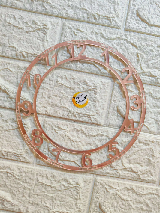 Rose gold circular clock number ring with raised numerals around inner ring