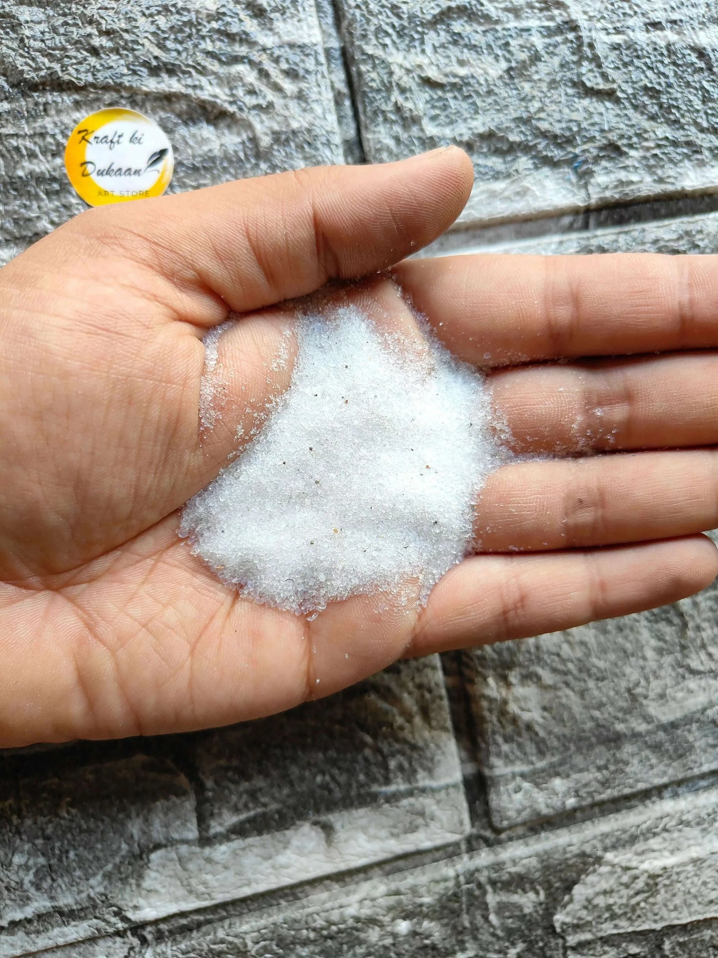 Silica gel white powder on palm in close-up, fine grains