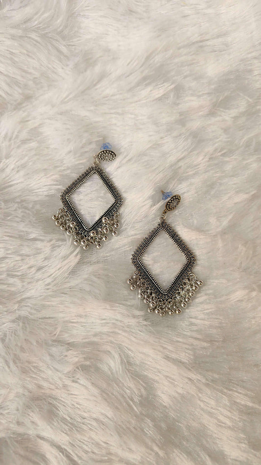Silver-toned jhumka earrings with blue stud tops, diamond frame and bead fringe