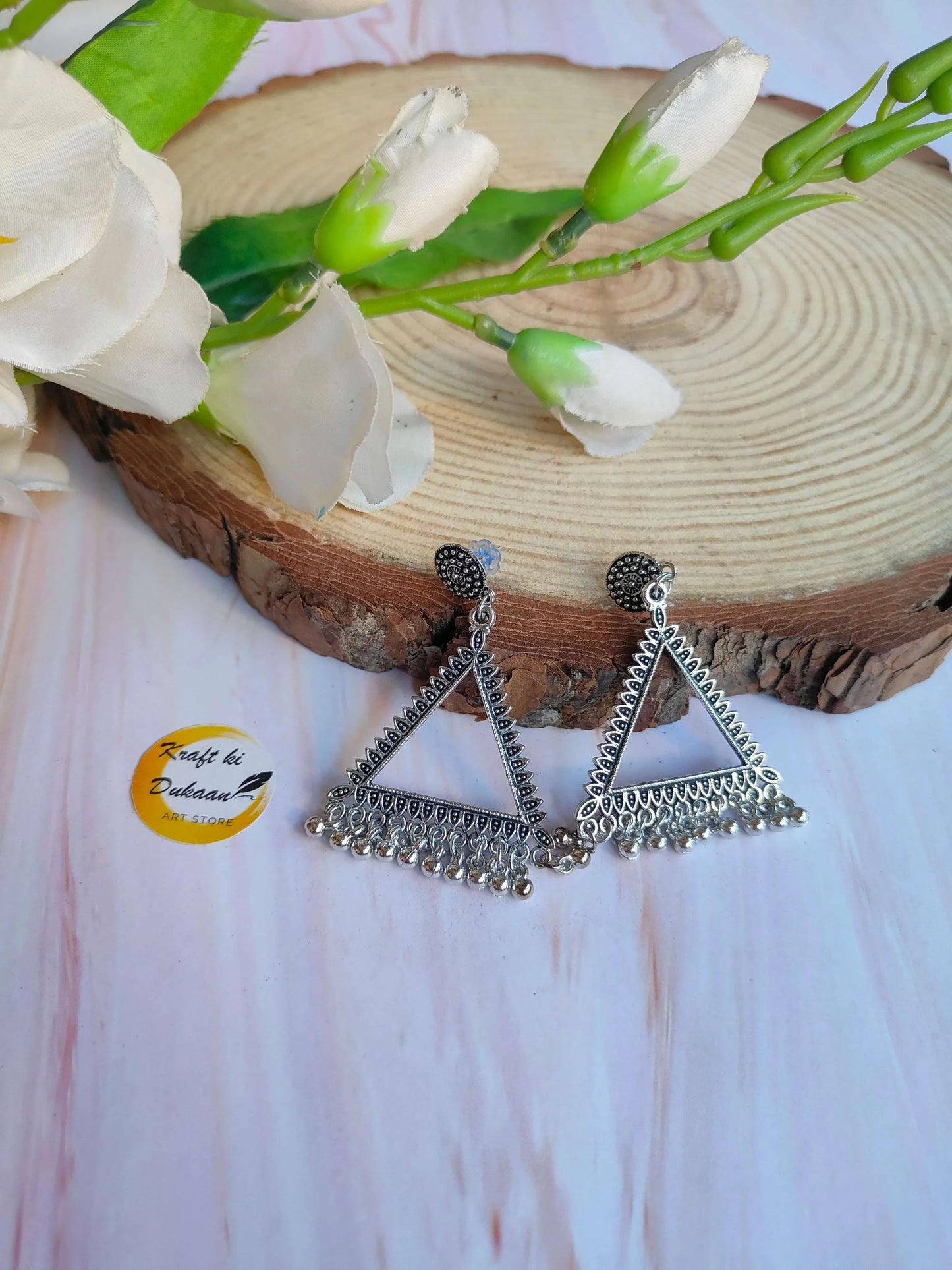 Silver jhumka-style earrings, teardrop top with triangular dangling ornament, no beads