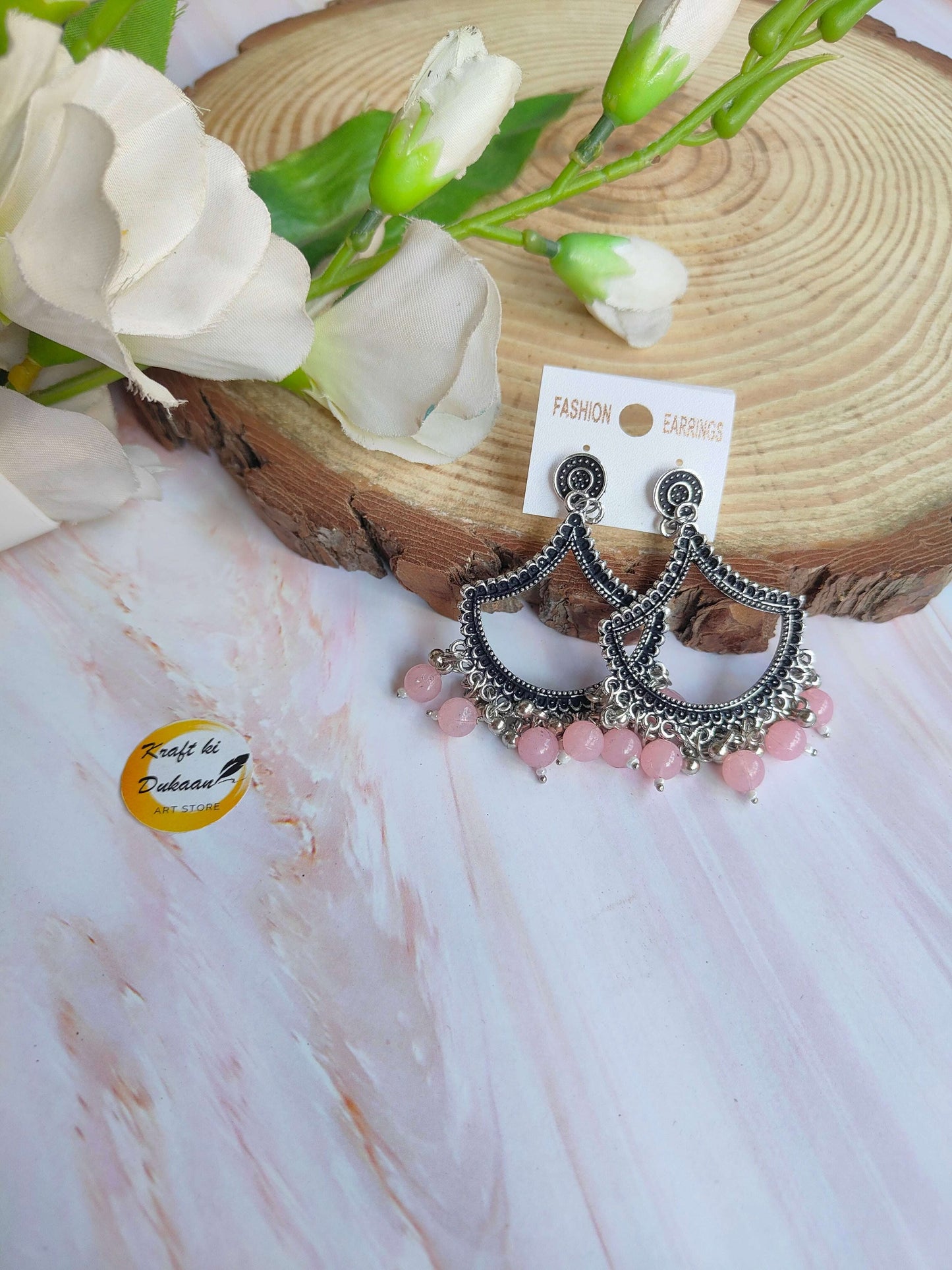 Stylish silver jhumka earrings with pink beads, perfect for festive occasions and everyday wear