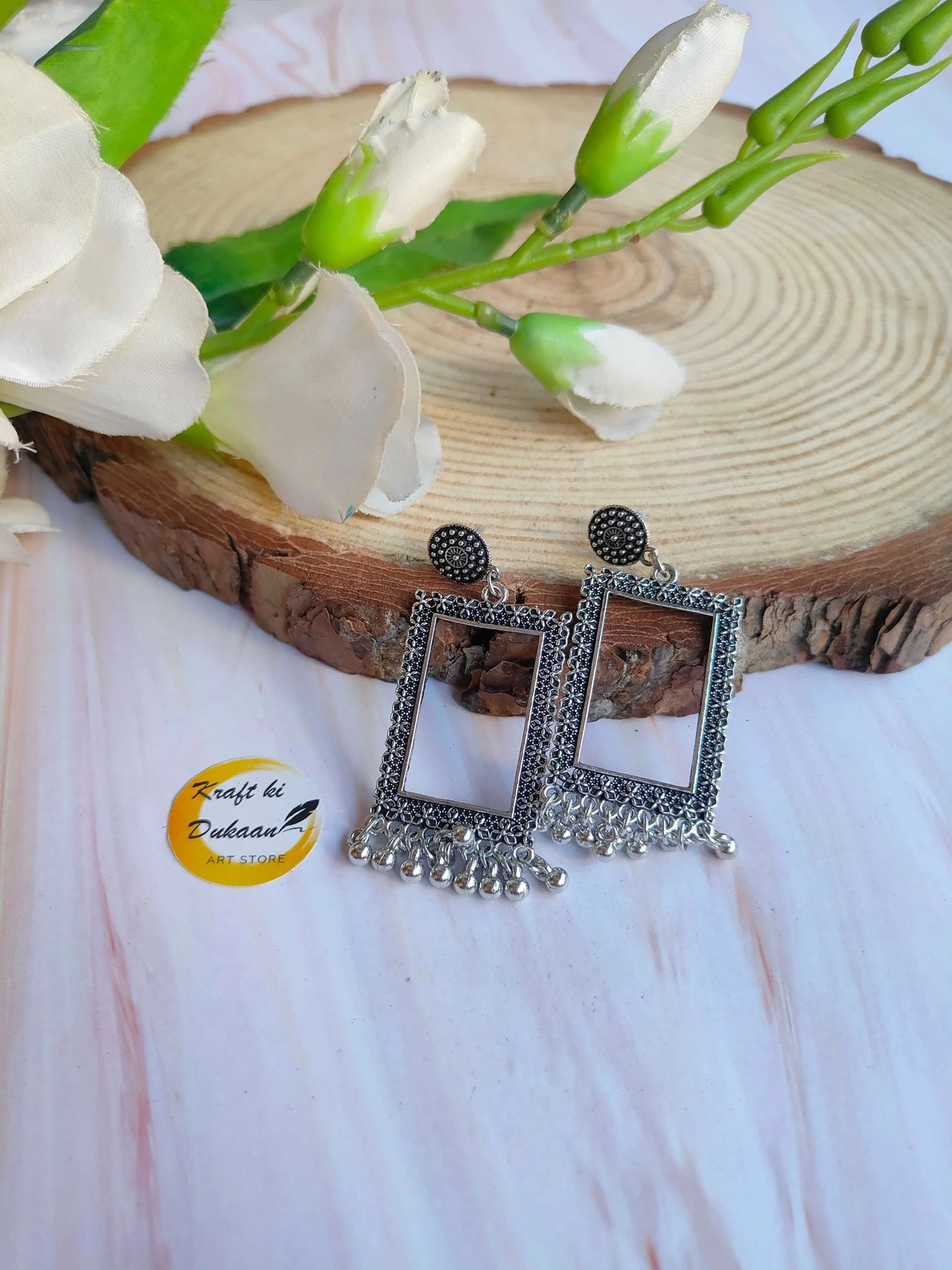 Silver jhumka earrings, square dangling frames with stud tops and ornate border