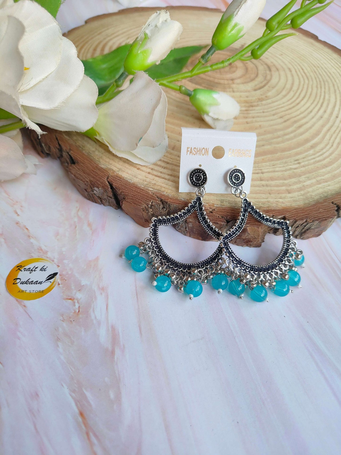 Stylish silver jhumka earrings with beads in turquoise color, perfect for any occasion