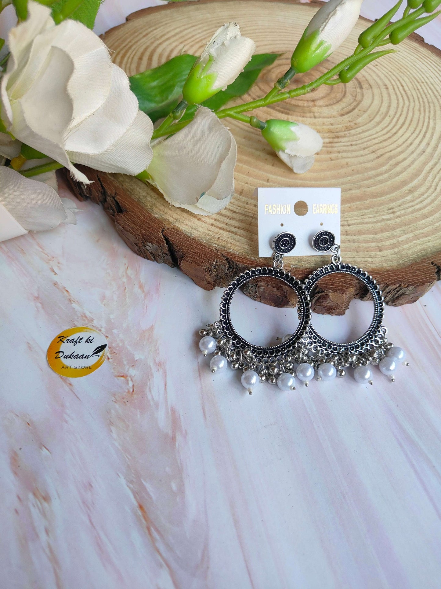 Stylish silver jhumka earrings with beads featuring intricate designs and dangling pearls