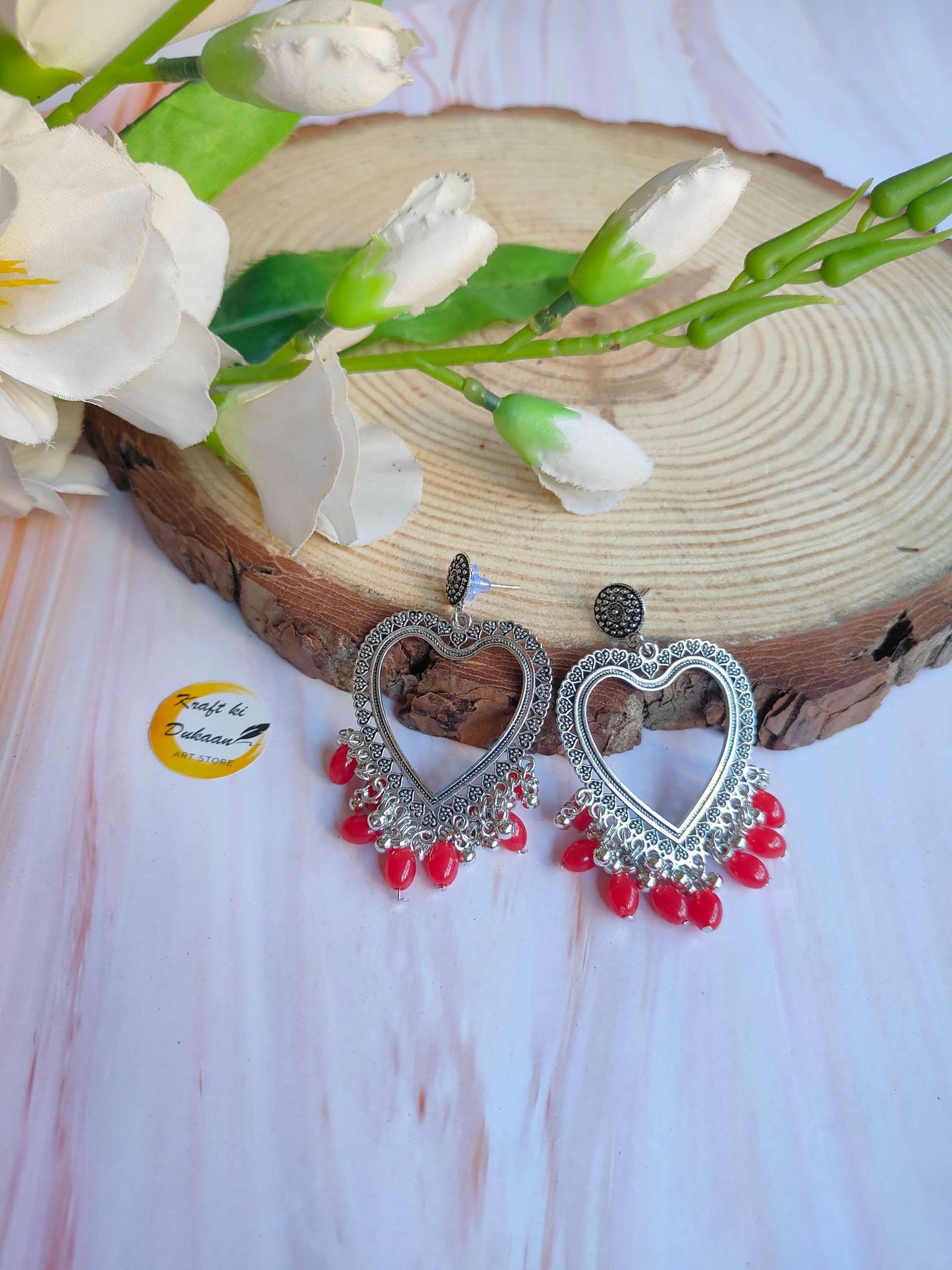 silver-jhumka-earrings-with-red-beads-heart-shape